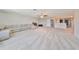 Open bonus room showcasing a sectional sofa and a wall of bookshelves at 9608 Ivory Dr, Ruskin, FL 33573