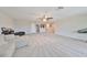 Spacious bonus room offering a sectional sofa and ample floor space at 9608 Ivory Dr, Ruskin, FL 33573