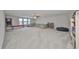Large bonus room with sectional sofa, shelving, and basketball game at 9608 Ivory Dr, Ruskin, FL 33573