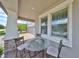 Cozy front porch with a glass-top table and chairs at 9608 Ivory Dr, Ruskin, FL 33573