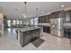 Open kitchen with island, stainless steel appliances, and granite countertops at 9608 Ivory Dr, Ruskin, FL 33573