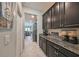 Kitchen features dark cabinetry and granite countertops at 9608 Ivory Dr, Ruskin, FL 33573