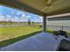 Covered patio with a grill and serene lake view at 9608 Ivory Dr, Ruskin, FL 33573