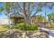 Lush landscaping surrounds a hot tub and a deck with porch swing in this tropical backyard at 9665 2Nd N St, St Petersburg, FL 33702