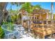 Inviting backyard with a wooden deck, cozy hammock, and lush tropical landscaping at 9665 2Nd N St, St Petersburg, FL 33702