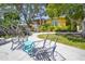 Chairs sit on a concrete patio in a tropical backyard setting at 9665 2Nd N St, St Petersburg, FL 33702