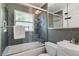 Bathroom featuring a shower-tub combo with a glass door, toilet, and vanity at 9665 2Nd N St, St Petersburg, FL 33702