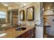 Bathroom featuring a granite countertop, tiled standup shower, and a large mirror at 9665 2Nd N St, St Petersburg, FL 33702