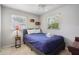 Bedroom featuring a twin bed, ceiling fan, tile floors, and natural light at 9665 2Nd N St, St Petersburg, FL 33702