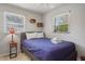 Bedroom featuring a twin bed, ceiling fan, tile floors, and natural light at 9665 2Nd N St, St Petersburg, FL 33702
