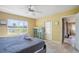 Bedroom featuring a queen bed, tile floors, a ceiling fan, and natural lighting at 9665 2Nd N St, St Petersburg, FL 33702