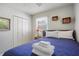 Cozy bedroom featuring a comfortable bed with a blue quilt and white linens and built in closets at 9665 2Nd N St, St Petersburg, FL 33702