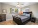 Bright bedroom with a gray quilt, travertine flooring and decorative artwork at 9665 2Nd N St, St Petersburg, FL 33702