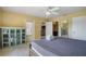 Bedroom featuring a queen bed, tile floors, a china cabinet, and open doorways at 9665 2Nd N St, St Petersburg, FL 33702