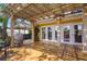 Inviting wooden deck with French doors, outdoor seating, grill, and a tiki hut at 9665 2Nd N St, St Petersburg, FL 33702