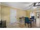 Dining room with light-yellow walls, travertine floors, modern furniture, and a ceiling fan at 9665 2Nd N St, St Petersburg, FL 33702