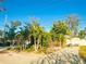 Beautiful one-story home with mature trees and a brick driveway in front of the garage at 9665 2Nd N St, St Petersburg, FL 33702