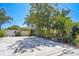 Charming one-story home with a well-maintained lawn and a driveway in front of the garage at 9665 2Nd N St, St Petersburg, FL 33702