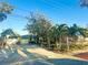 Inviting one-story home with mature trees and a long driveway in front of the garage at 9665 2Nd N St, St Petersburg, FL 33702