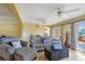 Bright living area with tiled floors, a large sofa, and access to outdoor deck through French doors at 9665 2Nd N St, St Petersburg, FL 33702