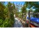 A stone walkway passes beneath a wooden arbor covered in flowering vines at 9665 2Nd N St, St Petersburg, FL 33702