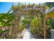 A vine covered arbor highlights a backyard walkway to the waterfront at 9665 2Nd N St, St Petersburg, FL 33702