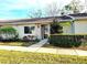 Attractive exterior of a light beige single-story home with well-manicured landscaping at 1000 Dunrobin Dr # C, Palm Harbor, FL 34684