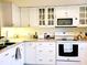 Bright white kitchen featuring ample cabinetry and modern appliances at 1000 Dunrobin Dr # C, Palm Harbor, FL 34684