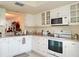 White kitchen with stainless steel appliances at 1000 Dunrobin Dr # C, Palm Harbor, FL 34684