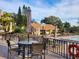 Relaxing pool area with patio tables and umbrellas for shade at 1000 Dunrobin Dr # C, Palm Harbor, FL 34684