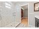 Spa-like bathroom with walk-in shower and wood-paneled accent wall at 1012 River Heights Ave, Tampa, FL 33603