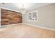 Dining room with hardwood floors and a rustic wood wall at 1012 River Heights Ave, Tampa, FL 33603