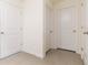 Hallway with tile flooring and access to bedrooms and bathroom at 1024 Golden Shiner Ave, Ruskin, FL 33570