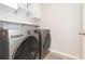 Laundry room with washer, dryer, and overhead shelving at 1024 Golden Shiner Ave, Ruskin, FL 33570