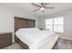 Main bedroom with a king bed, ceiling fan, and large window at 1024 Golden Shiner Ave, Ruskin, FL 33570