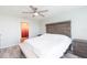 Bright main bedroom with a king-size bed and ensuite bathroom access at 1024 Golden Shiner Ave, Ruskin, FL 33570