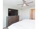 Main bedroom with a king-size bed and a large TV at 1024 Golden Shiner Ave, Ruskin, FL 33570