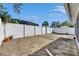 Large backyard with gravel and a white fence at 10313 Lakeside Vista Dr, Riverview, FL 33569