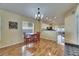 Dining area with hardwood floors, chandelier, and adjacent kitchen at 10313 Lakeside Vista Dr, Riverview, FL 33569