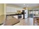 Bright kitchen with stainless steel appliances and view to backyard at 10313 Lakeside Vista Dr, Riverview, FL 33569