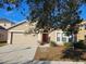 House exterior with a two-car garage and red front door at 10459 Fly Fishing St, Riverview, FL 33569