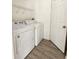 Laundry room with washer, dryer, and wood-look floors at 10459 Fly Fishing St, Riverview, FL 33569