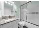 Bathroom with granite countertop, white cabinets and shower at 11441 Cypress Reserve Dr, Tampa, FL 33626