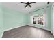 Bedroom with light green walls and window overlooking yard at 11441 Cypress Reserve Dr, Tampa, FL 33626