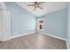 Light blue bedroom with wood-look floors and a window at 11441 Cypress Reserve Dr, Tampa, FL 33626