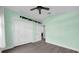 Light green bedroom with wood-look floors and double doors to closet at 11441 Cypress Reserve Dr, Tampa, FL 33626