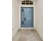 Inviting entryway with a blue front door and stone flooring at 11441 Cypress Reserve Dr, Tampa, FL 33626