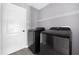 Convenient laundry room with washer, dryer, and shelving at 11441 Cypress Reserve Dr, Tampa, FL 33626