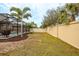 Landscaped backyard with a large pool and a privacy fence at 11550 Lake Lucaya Dr, Riverview, FL 33579