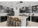 Spacious kitchen featuring dark cabinetry, granite countertops, and an island at 11550 Lake Lucaya Dr, Riverview, FL 33579